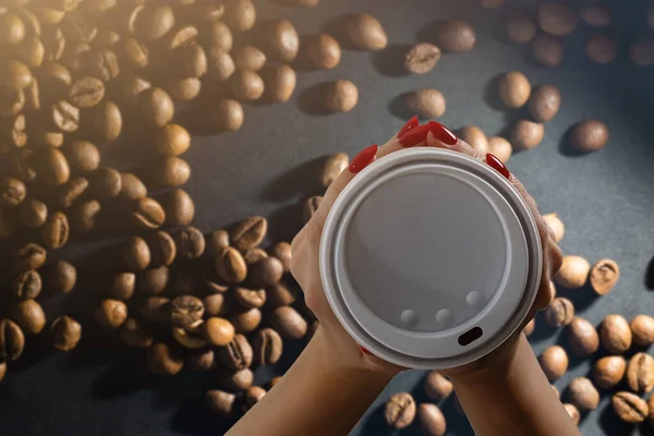 Takeaway cup with coffee and coffee beans — Stock Photo, Image