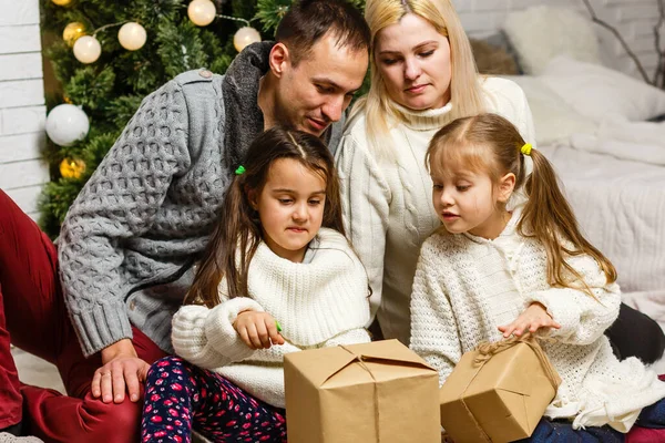 Szczęśliwy młoda rodzina gospodarstwa Boże Narodzenie prezent i uśmiech — Zdjęcie stockowe