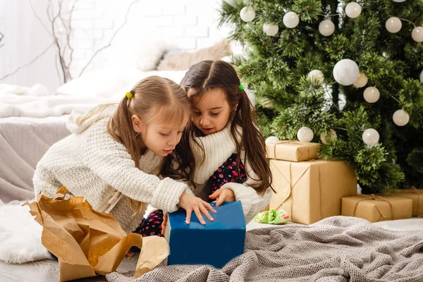 Zwei kleine Mädchen im weihnachtlichen Hintergrund — Stockfoto