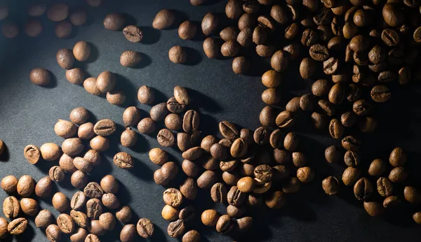 Flying coffee beans over dark — Stock Photo, Image