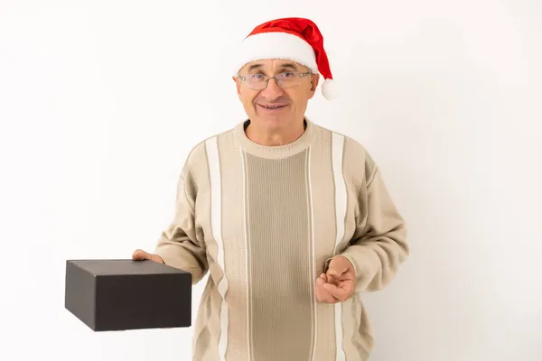 Yılbaşı hediyesiyle gülümseyen mutlu yaşlı bir adam. Beyaz arkaplan üzerinde izole edilmiş — Stok fotoğraf