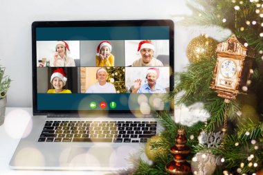 Atölyesindeki dizüstü bilgisayarında çeşitli mutlu çocukların olduğu bir video görüşmesi. Ev kavramında kişisel izolasyon ve sanal online kutlama. Noel