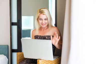 Kanepede dizüstü bilgisayar kullanan genç bir kadının yakın çekimi