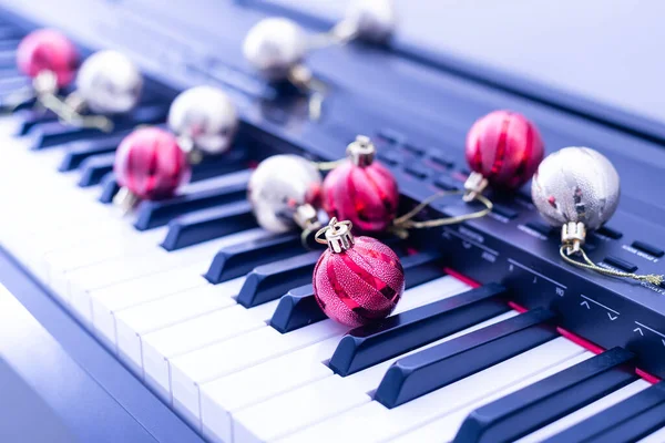 Ключи от фортепиано с рождественскими украшениями, крупным планом — стоковое фото
