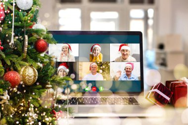 Atölyesindeki dizüstü bilgisayarında çeşitli mutlu çocukların olduğu bir video görüşmesi. Ev kavramında kişisel izolasyon ve sanal online kutlama. Noel