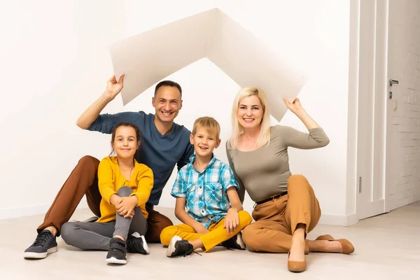 Happy family in a safe home - isolated over white background