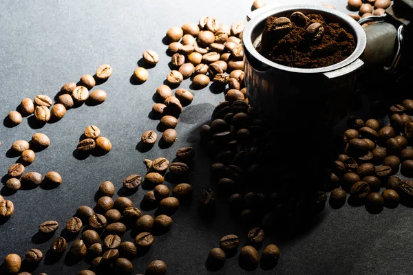 Coffee beans in the coffee machine horn. Postcard for cafes and restaurants. Close up. — Stock Photo, Image