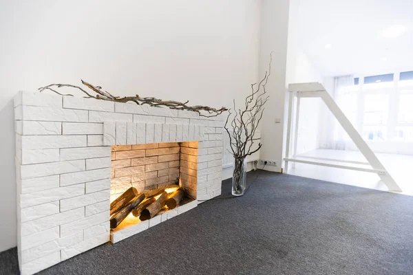 Decorative fireplace on the wall - modern interior. With a white brick. — Stock Photo, Image