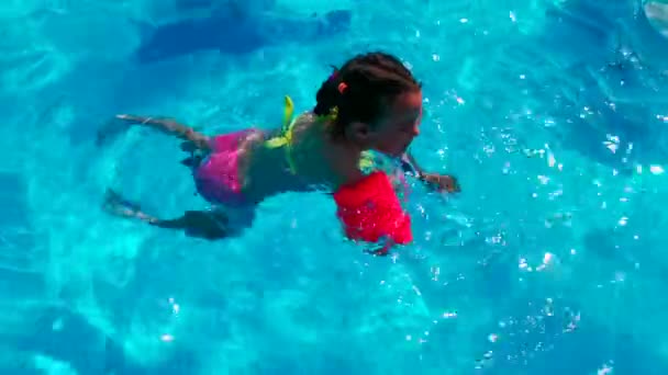 Adorable happy little girl in the swimming pool outside — Stock Video