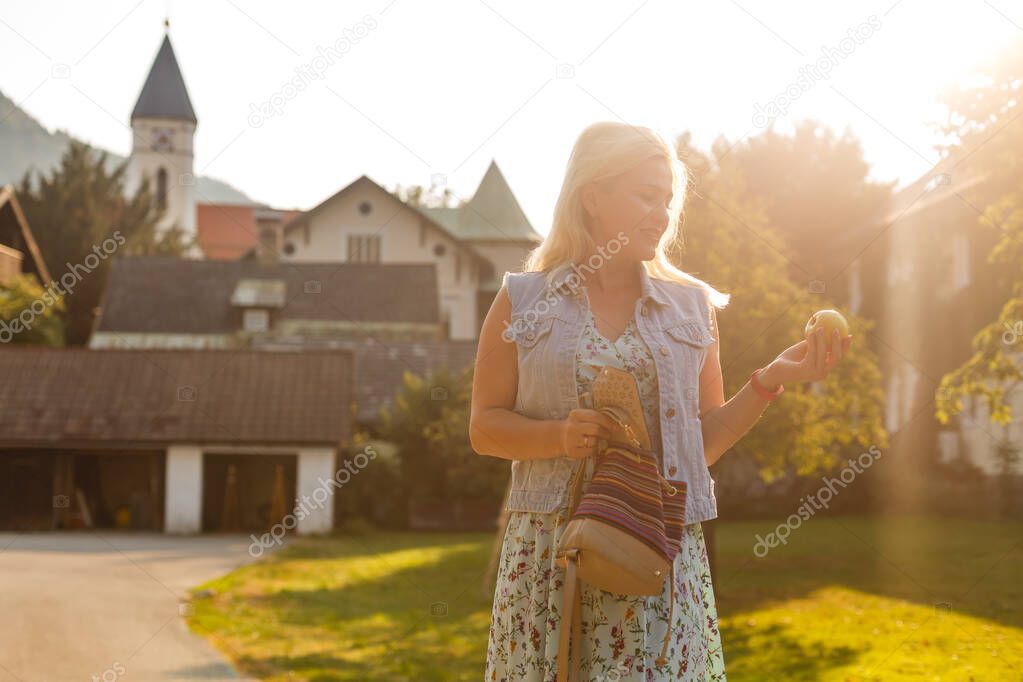 Young woman is standing by wooden houses. village in mountains. Travel, Lifestyle Concept. Alps, Europe.