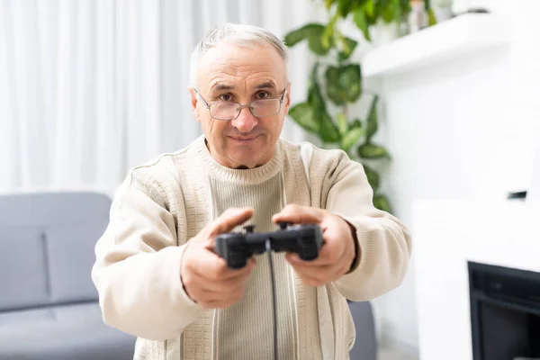 Senior man afspelen van video game op witte achtergrond — Stockfoto