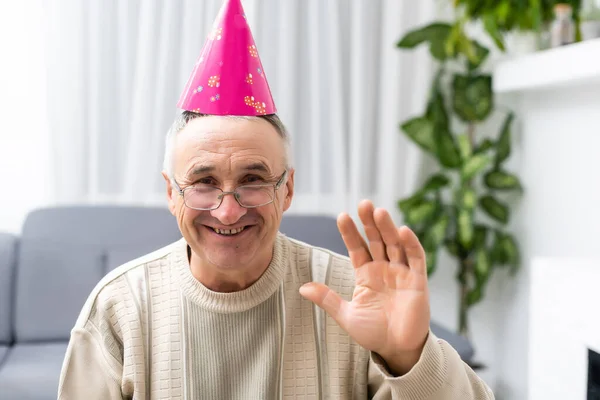 Old man in a party hat head shot. — Stock Photo, Image