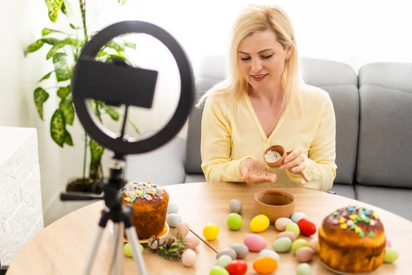 한 젊은 여성 이 부활절 달걀 장식에 관한 온라인 마스터 수업을 진행하고 있다. 무대 뒤에서 — 스톡 사진