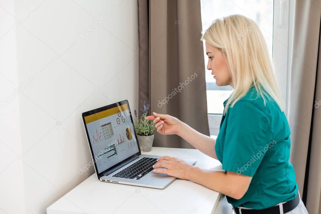 businesswoman analyzing statistics on laptop screen, working with financial graphs charts online, using business software for data analysis and project management concept, rear close up view