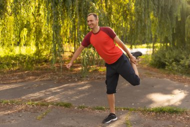 Stretching after jogging. happy man after jogging.