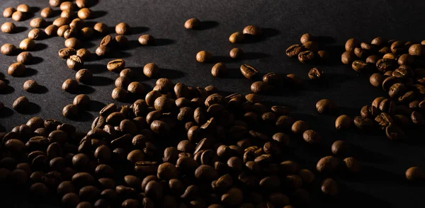 Flying coffee beans over dark — Stock Photo, Image