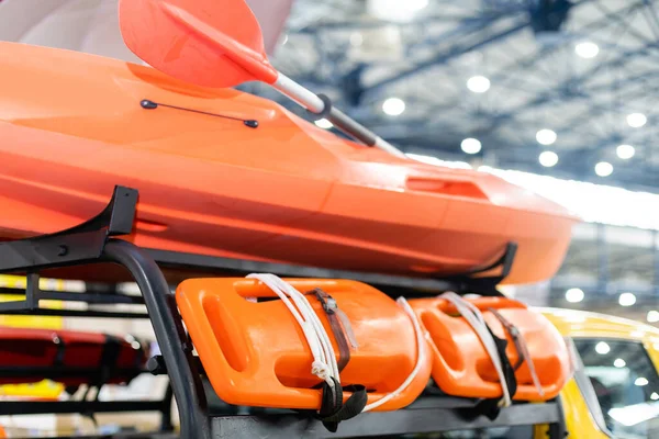 Orange lifeboat on display, paddle. — Stockfoto