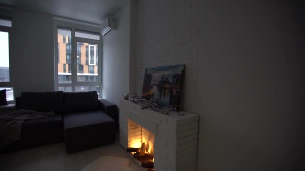 Living room interior in modern minimalist design style with burning fireplace. — Vídeo de Stock