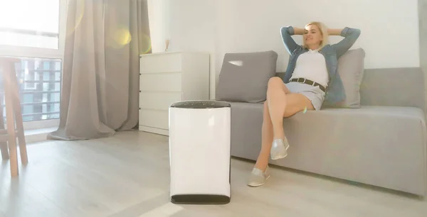 woman turn on air humidifier