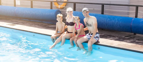 Young family, parents with children, in pool Royalty Free Stock Photos
