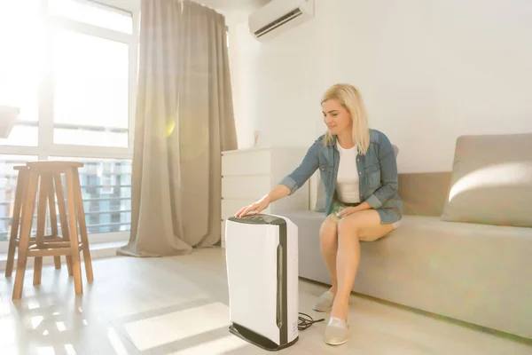 Air purifier in living room for clean and fresh air with woman — Stock Photo, Image