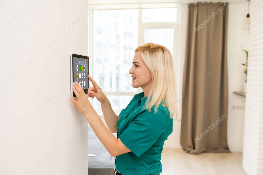 Woman at home using smart screen, automation domestic system