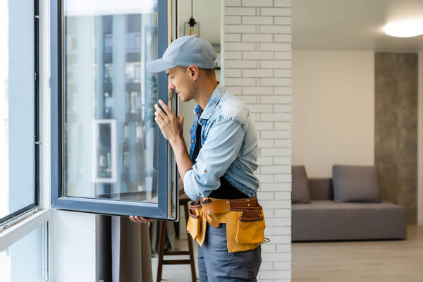 Construction Worker Installing New Windows In House