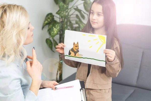 Kvinde skolepsykolog kommunikerer med en skolepige - Stock-foto