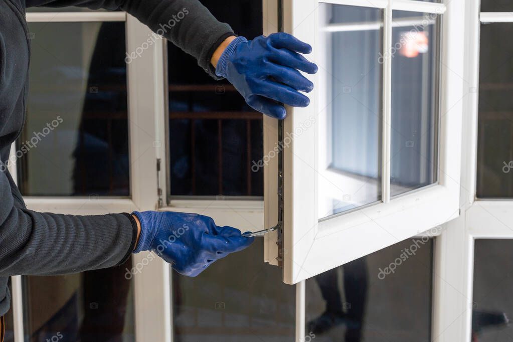 Professional handyman installing window at home