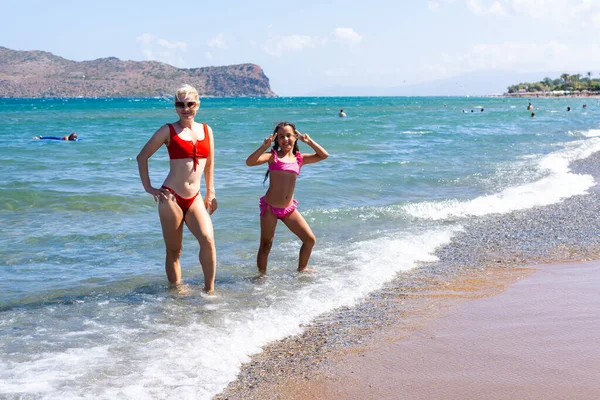 Молода мама і її маленька дочка насолоджуються пляжною відпусткою — стокове фото