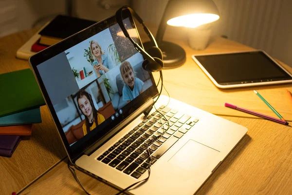 Online education of children. Girl schoolgirl teaches a lesson online using a laptop video chat call conference with a teacher at home — Stock Photo, Image
