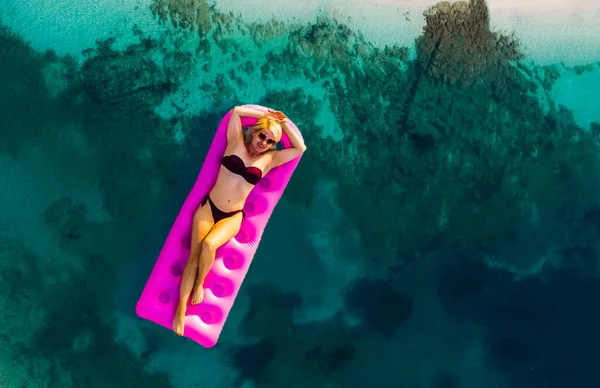 Woman on air mattress in the sea. Young woman on air mattress in the sea. — Stock Photo, Image