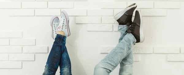 Affection feelings daydream meeting weekend holiday concept. Cropped portrait of legs in jeans sneakers, lovely romantic couple kissing hugging isolated on background — Stock Photo, Image