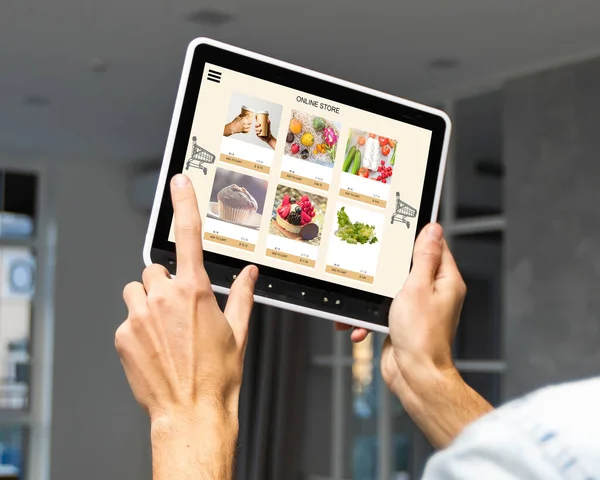 Uomo che utilizza tablet per ordinare la consegna del cibo a casa — Foto Stock
