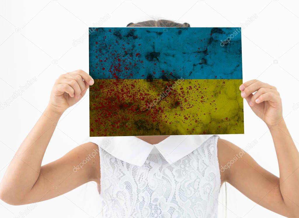 Little girl with Ukrainian flag on white background.