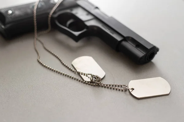 Gun, holster, dogtag, gauntlets on a white background — Stock Photo, Image