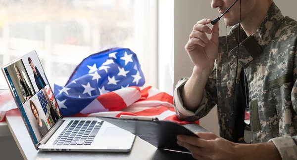 Olgun erkek asker ailesi ile iletişim için karargah binasında dizüstü bilgisayar kullanarak.