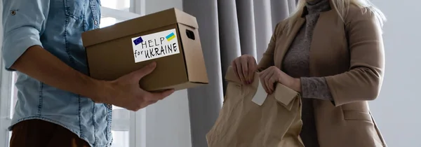 Volunteers collecting donations for the needs of Ukrainian migrants, humanitarian aid concept.