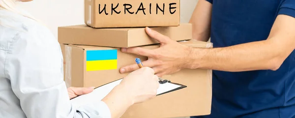 Volunteers collecting donations for the needs of Ukrainian migrants, humanitarian aid concept.