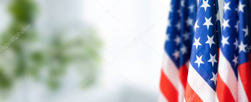 Group of American flags in green background.