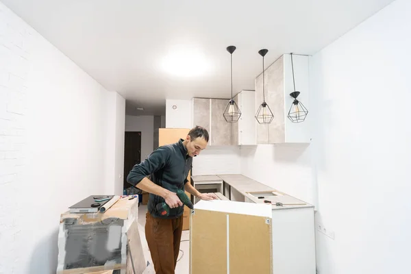 Furniture assembly - worker installing cabinet shelf — Stock Photo, Image