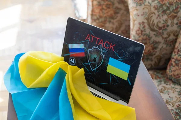 Online di belakang laptop dari rumah terhadap latar belakang bendera Ukraina, darurat militer di negara ini, siaran online berita lokal, menghentikan perang dan patriot — Stok Foto