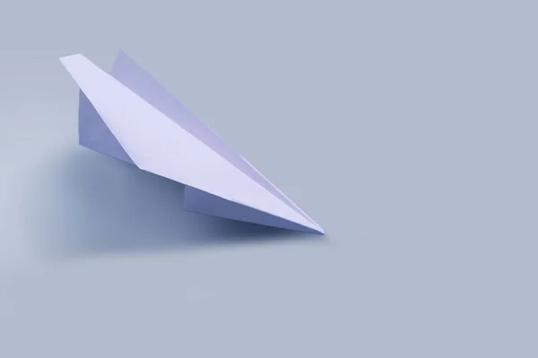 Paper airplane on a tone-harmonious background, toned — Stock Photo, Image