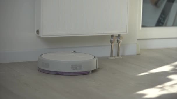 Robotic vacuum cleaner on laminate wood floor smart cleaning technology — Stock Video