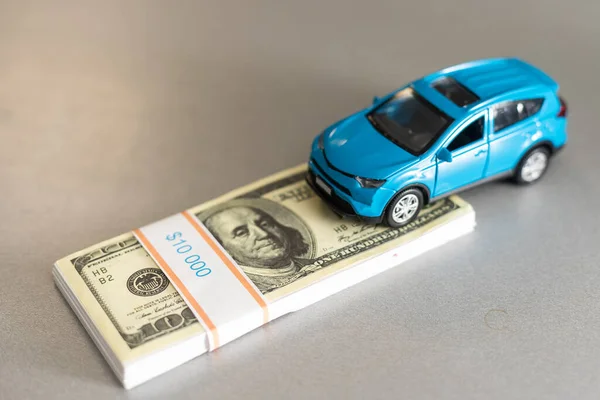 New car with keys and dollar banknotes on white background. — Stock Photo, Image