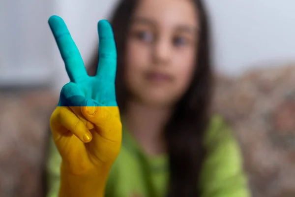 Peace hand kid Female and male hands painted in Ukraine flag colors holding. Stop the war — Stock Photo, Image