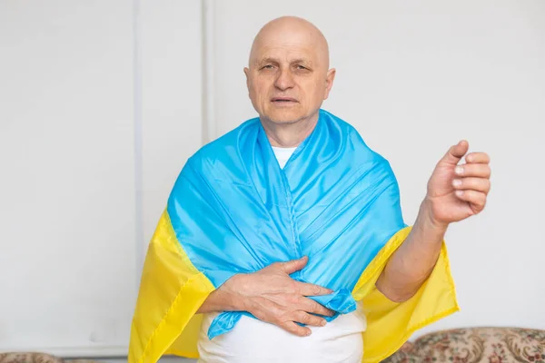 stock image elderly man with ukraine flag