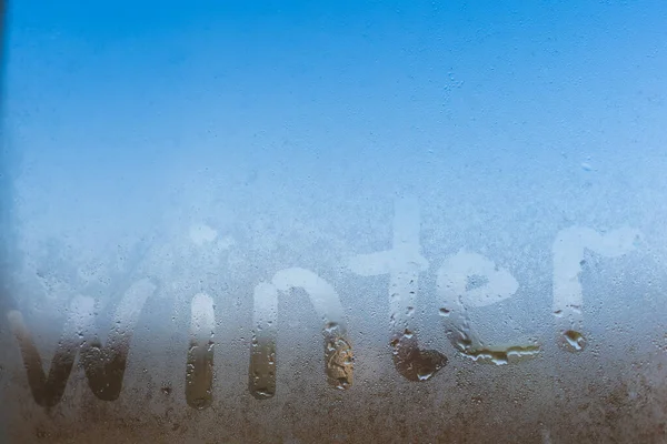 Word winter written on a foggy window — Stock Photo, Image