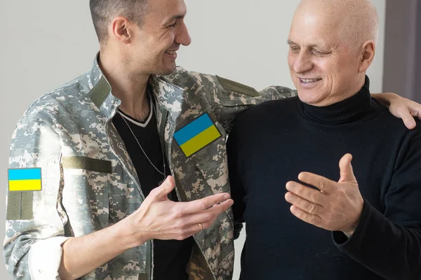 Elderly dad hugs a Ukrainian soldier. Militarization. Ukrainian defender says goodbye to his family. Mobilization of Ukrainian men. War of Ukraine and Russia