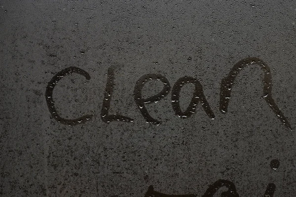 The word clean on a foggy window — Stock Photo, Image